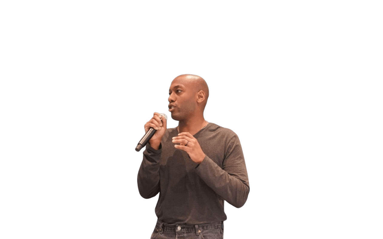 Keenan George speaking with a microphone